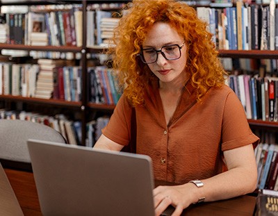 Librarian cataloging on laptop