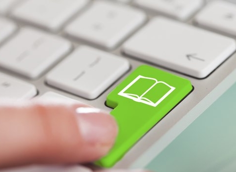Computer keyboard with green book key