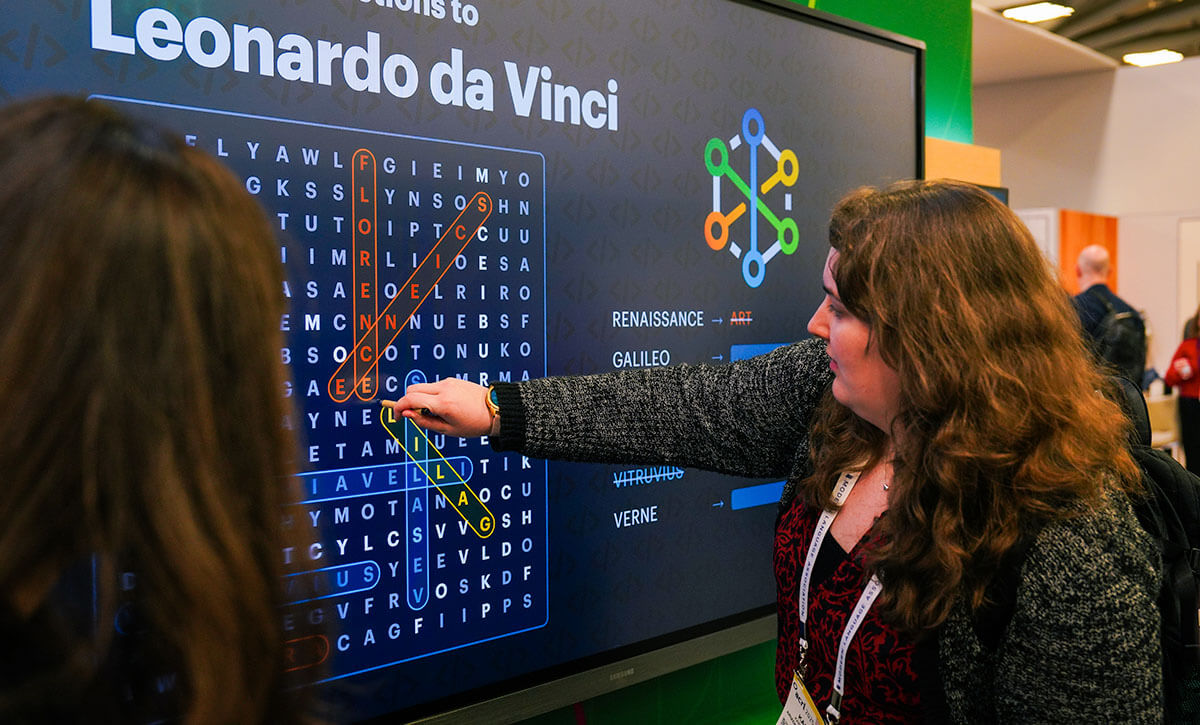 Photo: Visitor playing word find game at OCLC ACRL booth